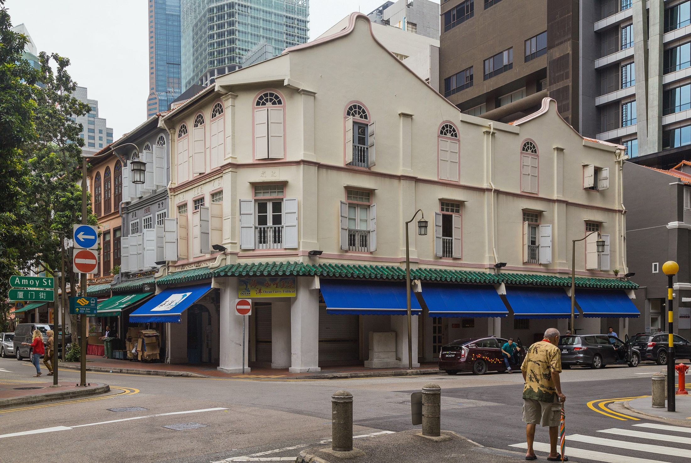 Restored shophouses on Telok Ayer Street at the corner of Amoy Street, Singapore, with office towers behind